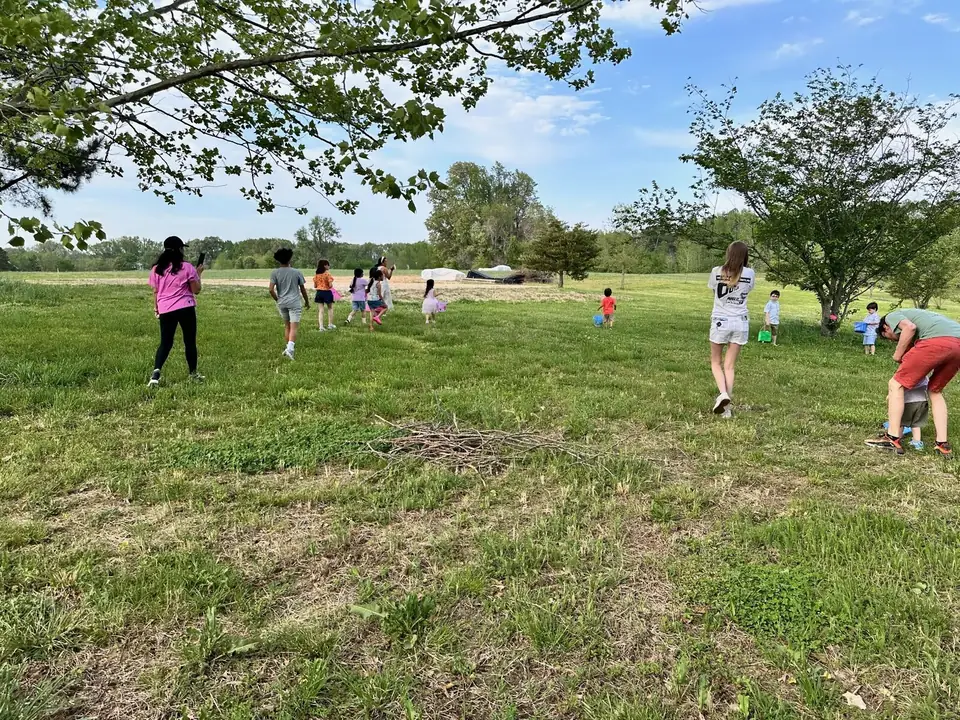 Children running across an open grassy field