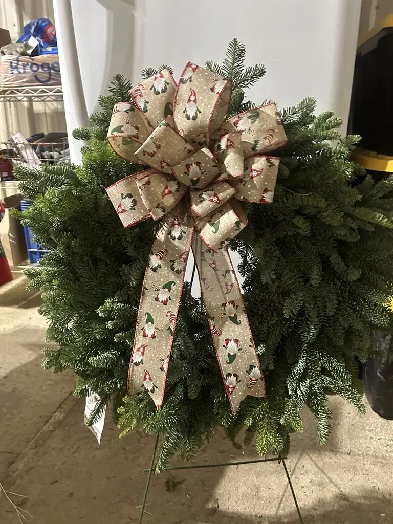 A wreath with a patterned ribbon bow
