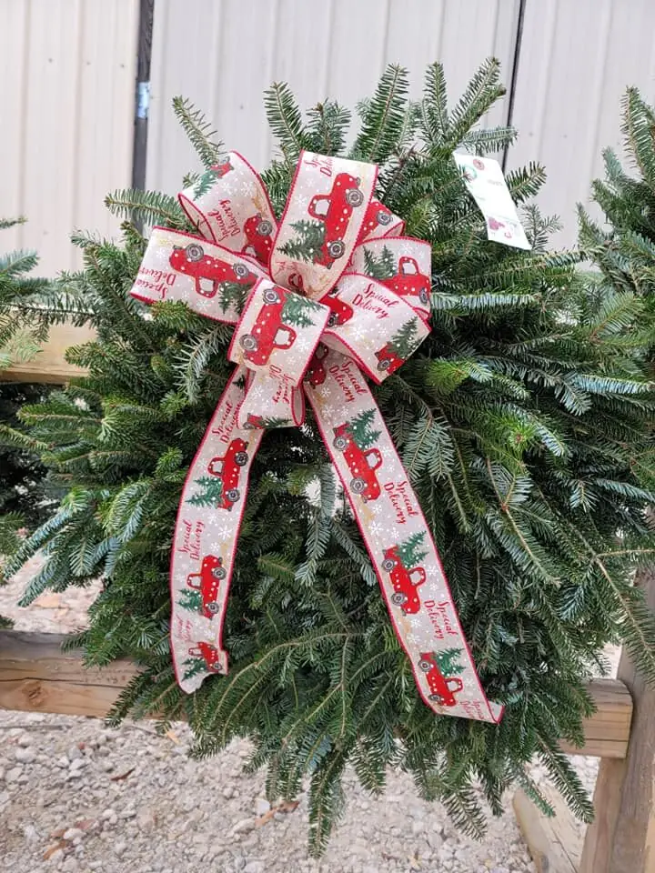 A wreath with a red-truck ribbon bow