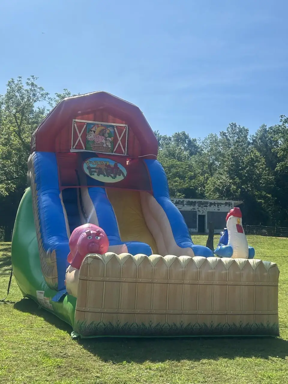 An inflatable barn-themed slide