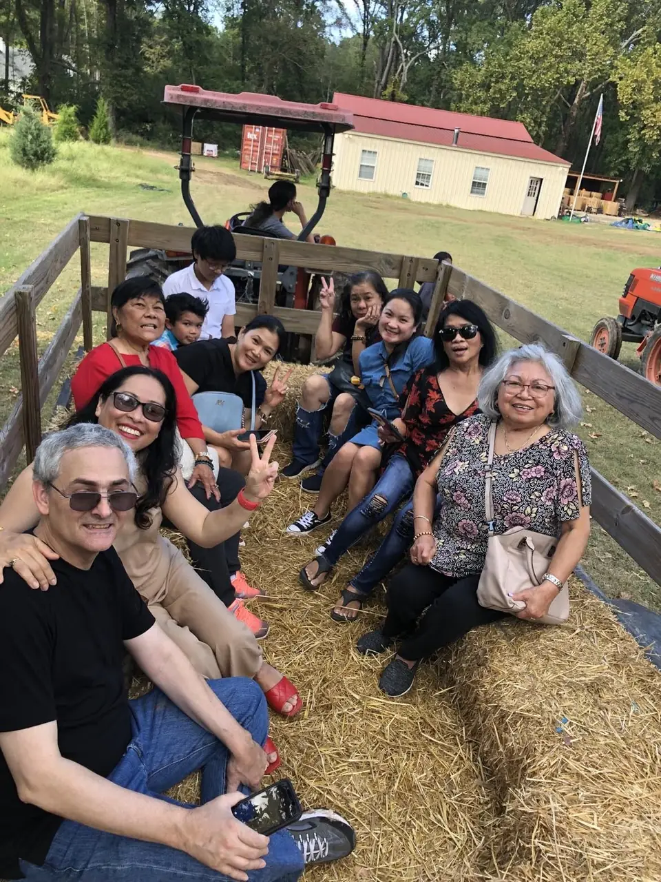 A group of visitors on a hayride wagon